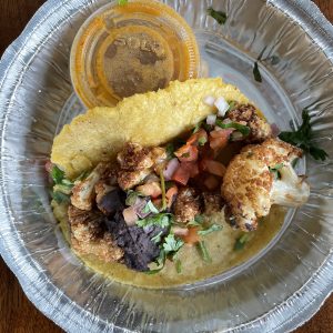 Served in a separate container to keep its veggie purity free from meat juices, Con Huevos' roasted cauliflower taco gets a flavor boost from black beans, pico de gallo, and fiery habanero salsa on the side.