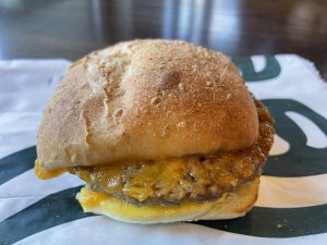 The Impossible Breakfast Sandwich at Starbucks features Impossible's plant-based breakfast sausage sandwiched with egg and cheese on a soft ciabatta bun. 