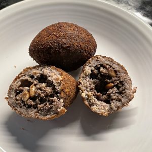Small but intense, kibbeh are formed into mini football shapes from chopped beef, bulghur wheat, onions, and pine nuts.