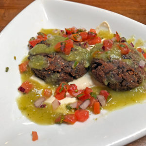 Black bean cakes with cashew aioli and salsa verde at Noosh Nosh.