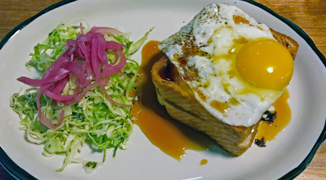 Grilled cheese sandwich topped with a fried egg at Portage House.