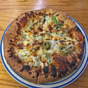 Charlestown Pizza Company’s regular pizza with green peppers, onions and green olives.