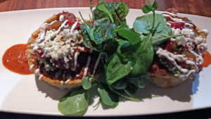 Sopes, small fried masa bowls filled with Black Angus short ribs at Guaca Mole