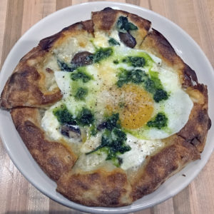 Red Hog’s three-cheese pizza with spinach and fried farm egg.