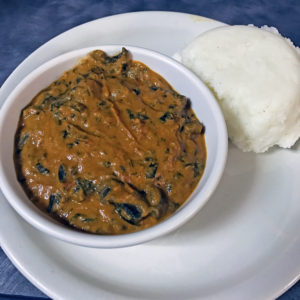 Funmi’s mushroom peanut-tomato stew with spinach and tuwo cornflour meal.