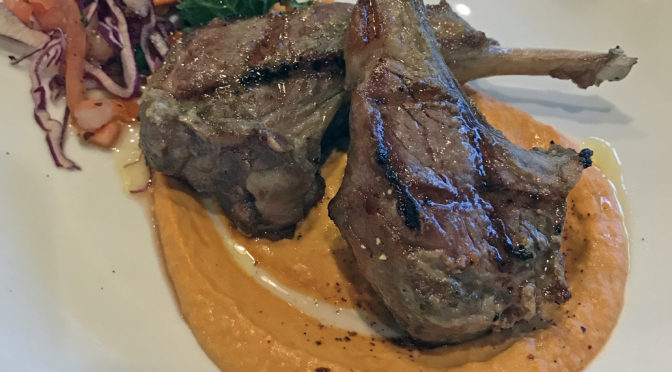 Mojito’s chuleta de cordero, grilled lamb chops with piquillo hummus.