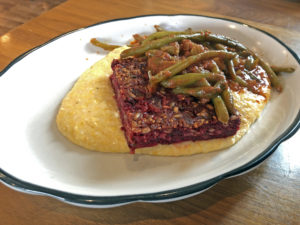 Josh’s beet loaf with grits and tomato-braised green beans at Couvillion.