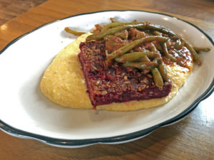 Josh’s beet loaf with grits and tomato-braised green beans at Couvillion.