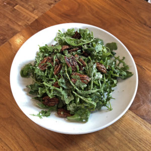 Couvillion’s simple salad with arugula and candied pecans.