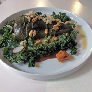 Mole poblano relleno on cheese grits and kale leaves at Naïve.
