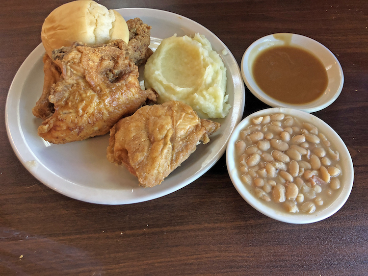 Cottage Inn’s iconic fried chicken, with mashed potatoes and gravy and a side of white beans.