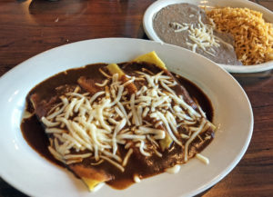 Cheesy enchiladas bathed in piquant chile sauce at Cancun Mexican Restaurant.