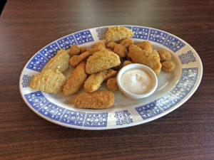 The Southern Sampler plate at Cottage Inn: A hearty mix of sizzling fried green tomatoes, fried okra, and jalapeño poppers.
