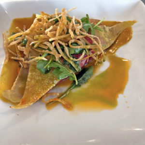 From Kaelin’s entree list, the pan-seared ravioli sport a seasonal vegetable filling.