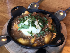 Seasonal fruit elevates a delicious peach cobbler at Portage House.