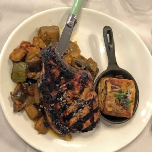 Brasserie Provence’s prime pork chop with lavender-honey glaze on ratatouille with gratin dauphinois.