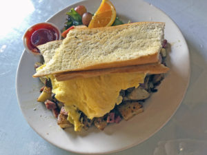 The Café’s roasted potato mixed grill hash, a hearty dish featuring eggs and three kinds of hash.