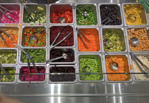 Bright veggies set out in square pans make a colorful display on CoreLife’s service line.