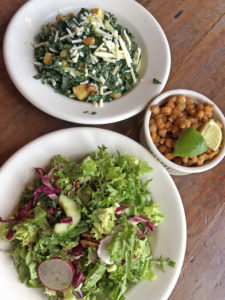 The Eagle’s country green salad, kale salad and hominy corn nuts all await our attention.
