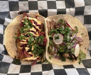 A pair of tacos – fried cod (left) and carnitas – at Taco City.