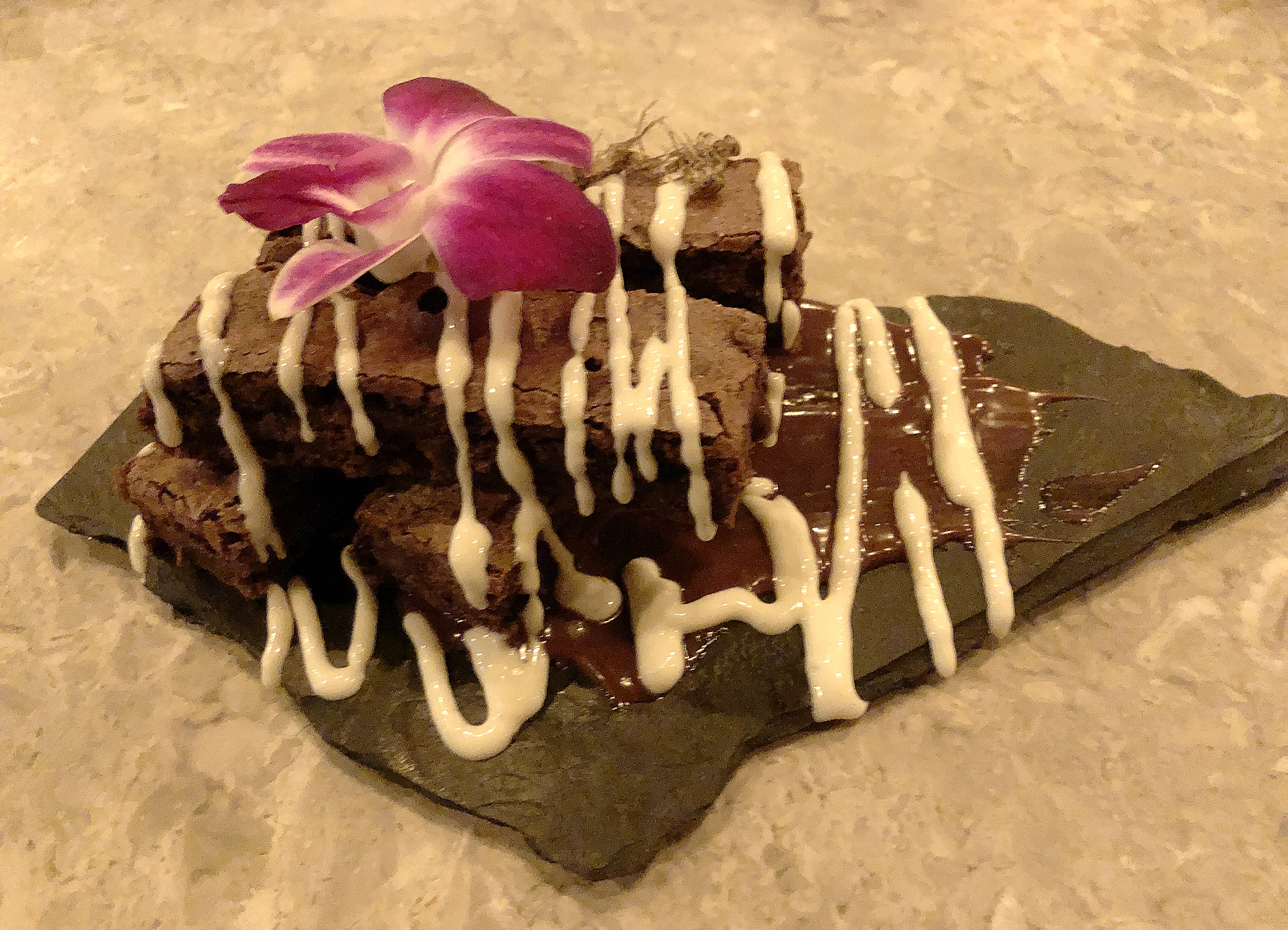 The cricket brownies at Ostra don’t taste like crickets. They taste like brownies.