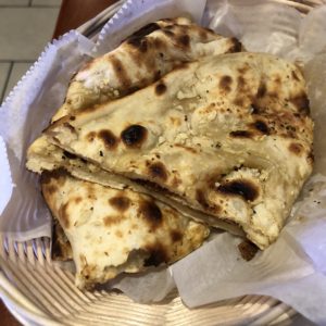 Garlic naan at Louisville Cafe India, a classic Indian wheat flatbread baked in the tandoor oven.