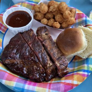 Three thick, firm and meaty pork ribs at Holy Smokes, with collards, cabbage casserole, and a dinner roll.