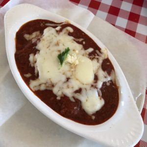 Ravioli comes smothered in thick pasta sauce and a blanket of mozzarella at Milantoni.