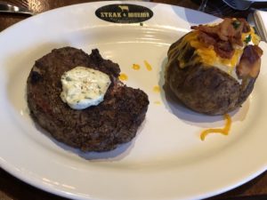Steak & Bourbon’s 14-ounce Certified Angus rib eye steak and loaded baked potato. 