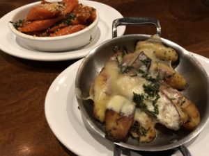A couple of side dishes at Steak & Bourbon: maple-glazed carrots and raclette potatoes.
