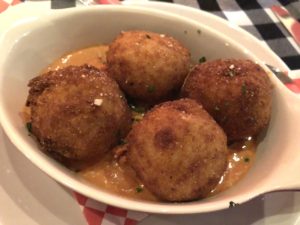 Palatucci’s mozzarella-stuffed arancini risotto balls are as good as we ever ate.