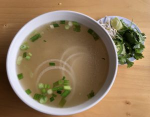 Clear meat-free pho at Pho Phi gains deep, complex flavor with the addition of the accompanying herbs and jalapeños.