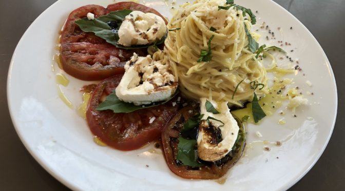 Wiltshire at the Speed’s cacio e pepe pasta, plated with fresh heirloom caprese salad.