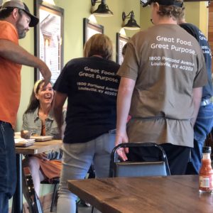 Volunteers carry much of the load at The Table. You can tell them by their colorful T-shirts and their smiling faces.