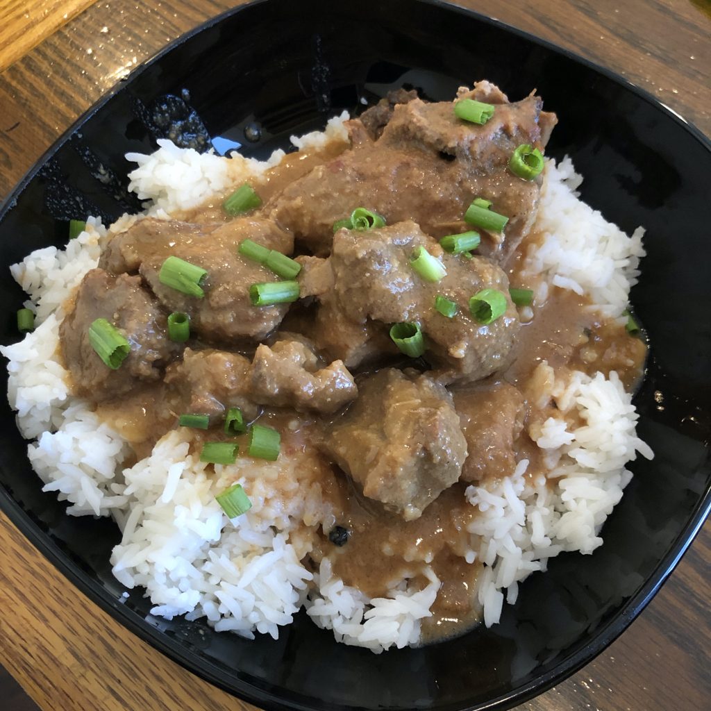 Lola’s Kitchen’s chicken and pork adobo on a bed of rice.