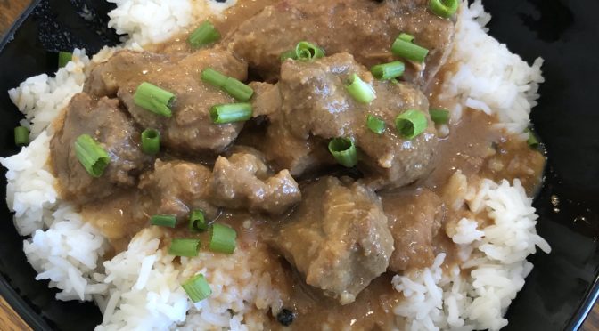 Lola’s Kitchen’s chicken and pork adobo on a bed of rice.