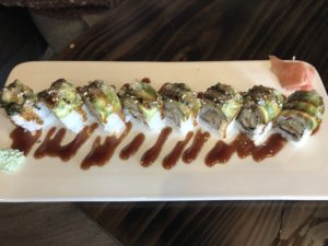 Jasmine’s Wonderland sushi roll is topped with avocado, filled with eel, and drizzled with sweet brown sauce.