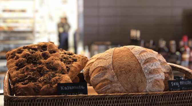 Artisan loaves in open baskets await buyers at Butchertown Grocery Bakery.