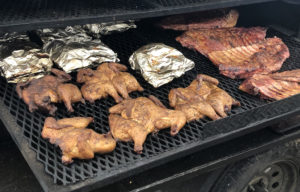 The smoker at Galan's butcher shop is loaded down with chickens, racks of ribs, and shredded spicy beef.