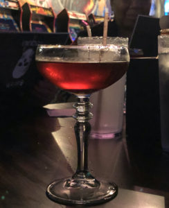 The Agave & Rye cocktail, a riff on the Manhattan, glimmers in the game room light.