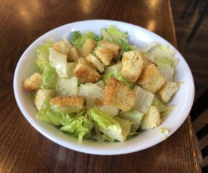 Tossed caesar salad with tasty garlic-herb baguette croutons at Union 15. 