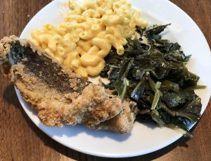 Plated to enjoy at home, LuCretia's boneless whiting fillets are fried crisp, flaky, and perfectly cooked. They were served with excellent greens, macaroni and cheese, and a block of cornbread. 