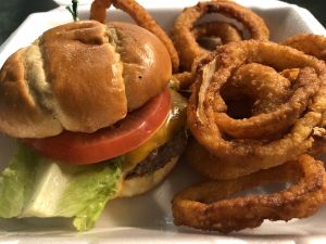 Neatly packed in its plastic foam box, Shady Lane's Brownsboro burger and onion rings arrive home safe and sound.