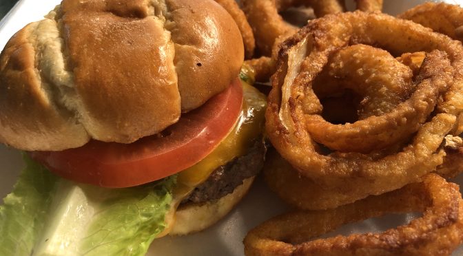 Neatly packed in its plastic foam box, Shady Lane's Brownsboro burger and onion rings arrive home safe and sound.