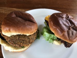 Two meatless BurgerIM specialties, a burger-size falafel and an Impossible Burger. 