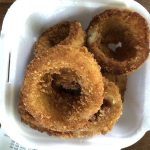 BurgerIM's fat, sweet onion rings, are thickly coated with crunchy panko breading fried dark golden brown.