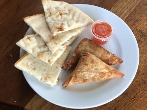 Indian-style fried sambusas and pita quarters at Funmi's reveal the many culinary echoes in African cuisine.