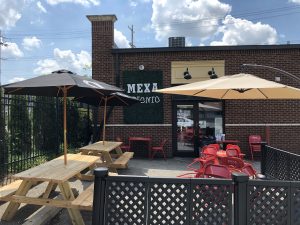 MexA Steak Tacos has set up a spacious patio area with picnic tables and umbrellas on part of its parkling lot behind the building.