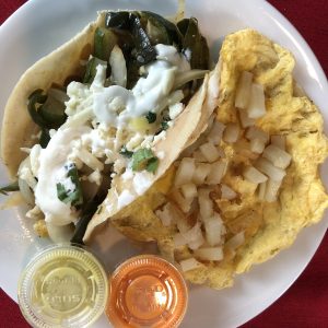Two meatless treats from MexA: A veggie taco with zucchini, poblano peppers, onions, cheese and crema, and a breakfast taco with scrambled eggs, potatoes, beans and cheese.