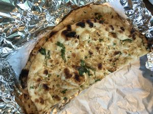 Taj Palace's garlic naan, soft and intensely garlicky flatbread from the tandoor oven.